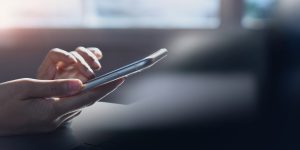 Closeup, woman hand using mobile smartphone, surfing the internet, web browsing via mobile app, social media, network, side view, internet technology, online marketing