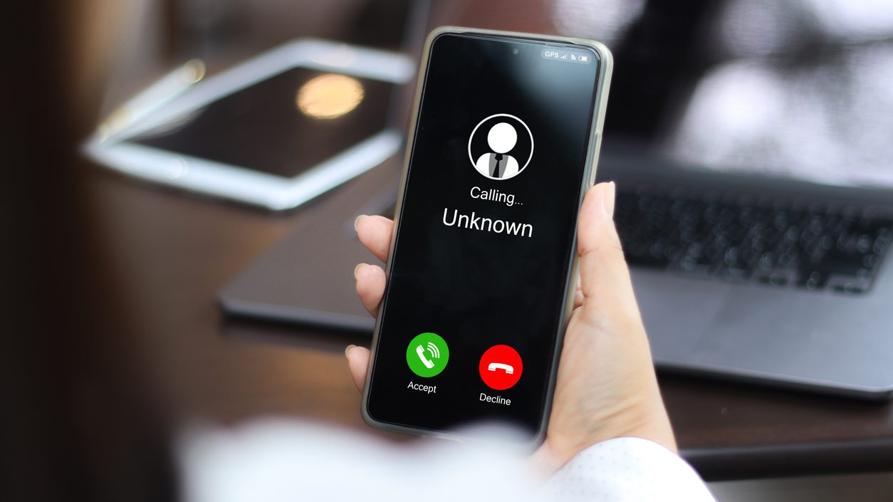 Unknown number displayed showing on smart mobile phone. Human use smartphone with incoming call from unknown number, spam, hacker, call center, crime,