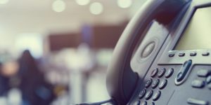 close up telephone VOIP technology standing on office desk in monitoring room for network operation center job concept