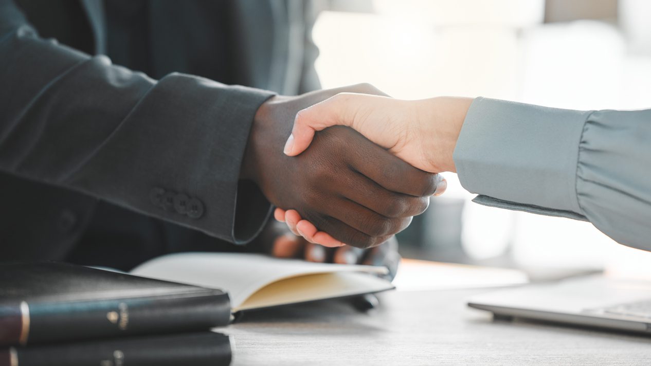 Business people, handshake and lawyers for introduction, agreement and greeting or recruitment. Partnership, closeup and integration or support in court case, network and thank you for hiring on desk