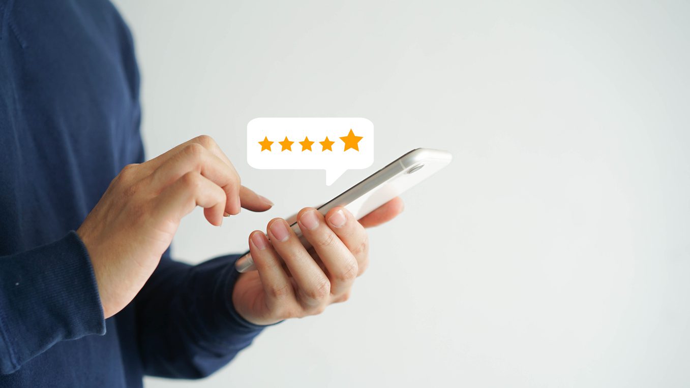 close up on customer man hand pressing on smartphone screen with  five star rating feedback icon and press level good rank for giving best score point to review the service , technology business concept