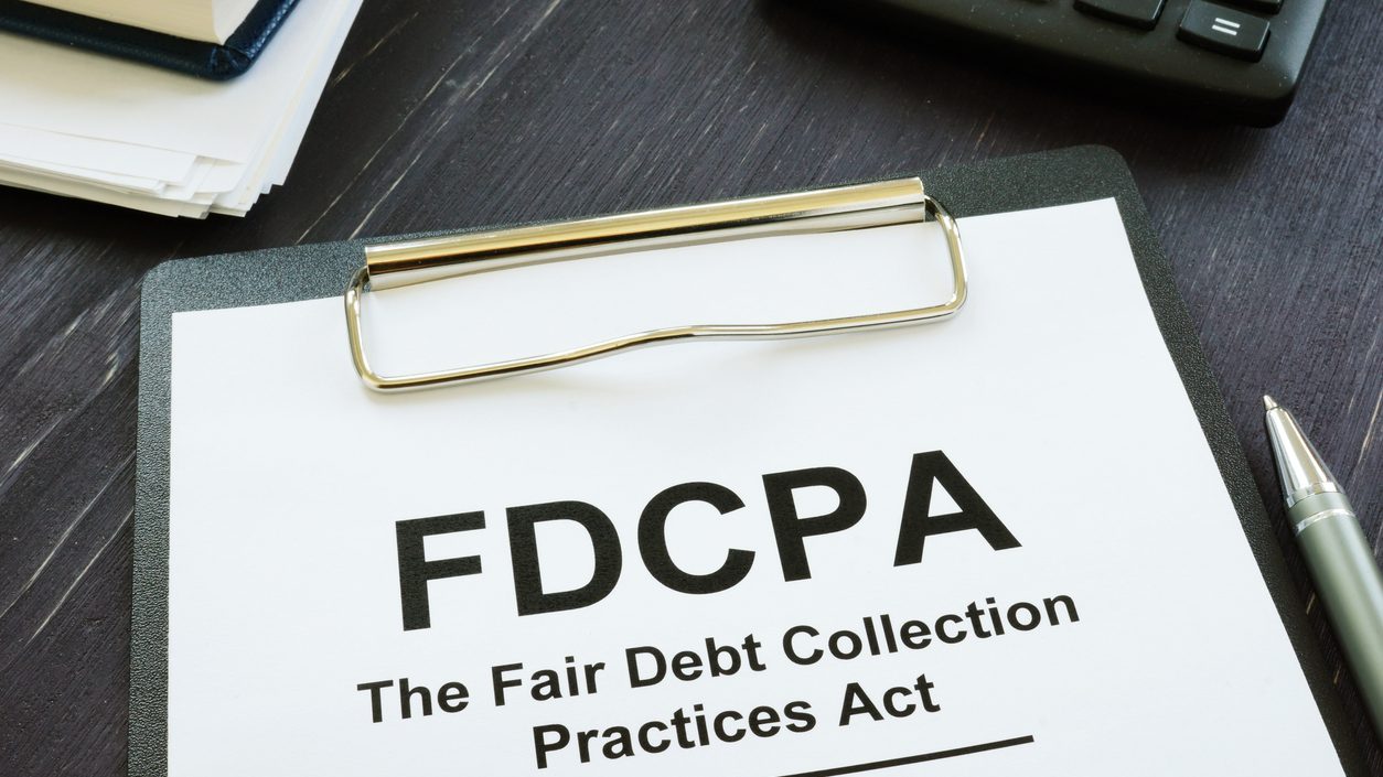 Writing note shows the text FDCPA The Fair Debt Collection Practices Act